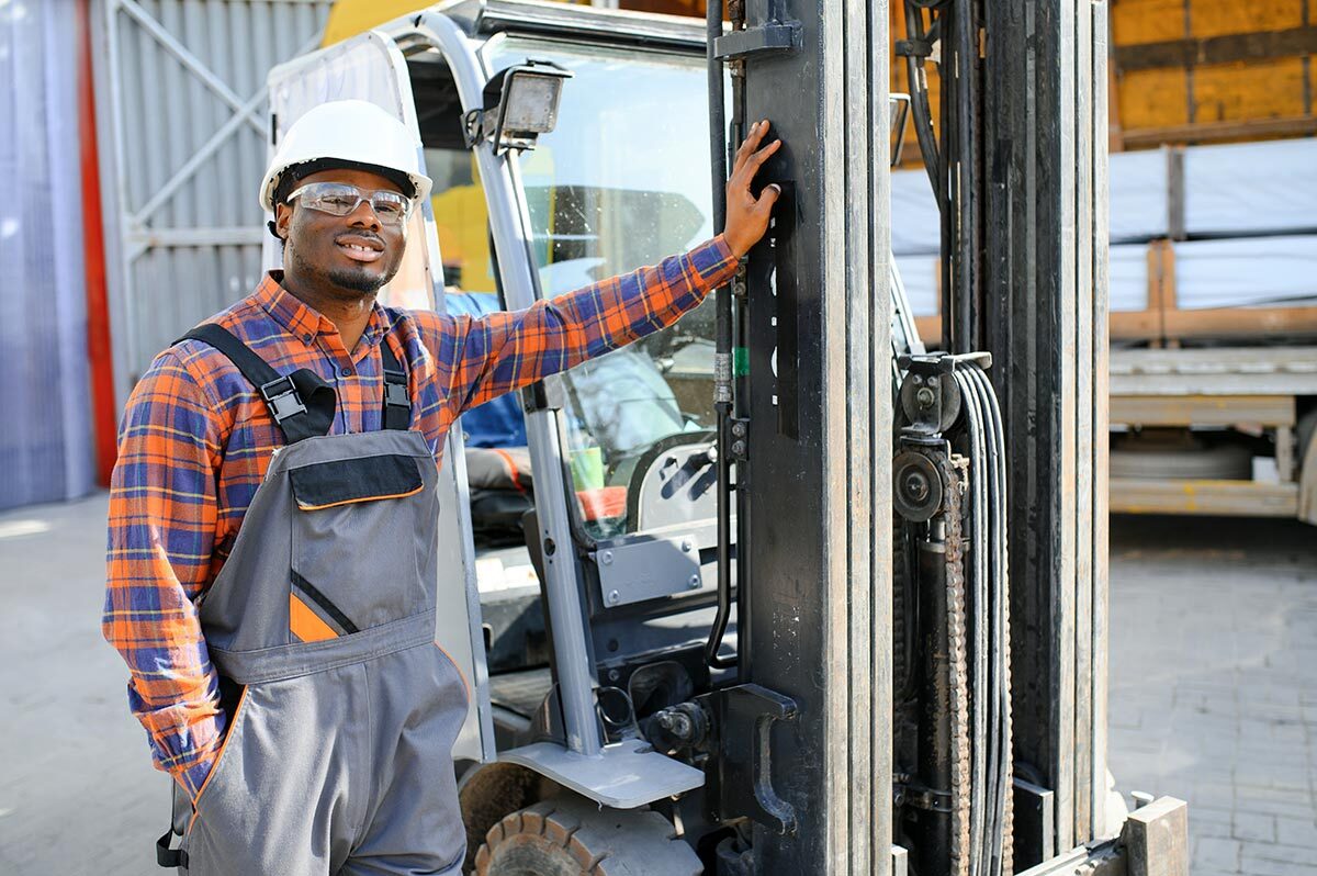 Logistics worker as a forklift driver in the warehouse of a freight forwarder.