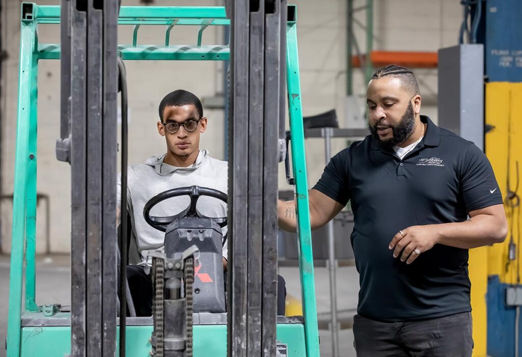 Instructor teaching student in a VersAbility forklift class