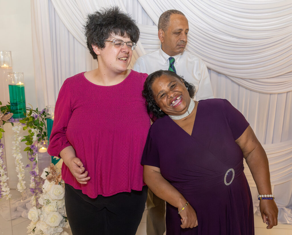 Three people smiling together for the camera