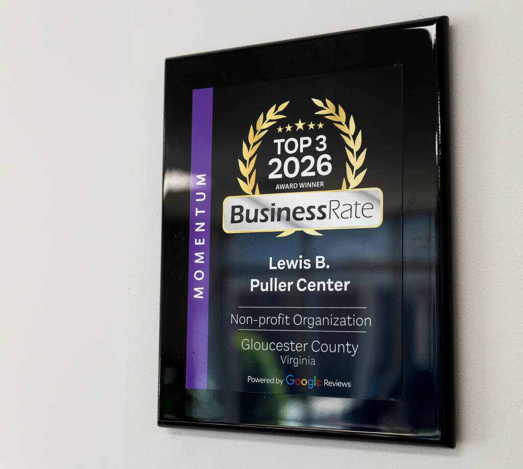 Plaque on wall: "Top 3 2026 Award Winner, BusinessRate, Lewis B. Puller Center, Gloucester County, Virginia, Non-profit Organization."